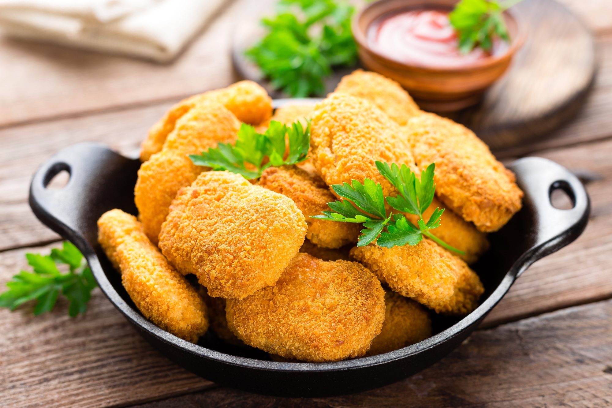 Nuggets. Chicken nuggets with ketchup on wooden table. Fast food